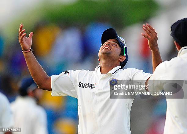 Indian players Suresh Raina looks at the sky after rain led to a draw, at the end of the fifth day of the second test match between West Indies and...