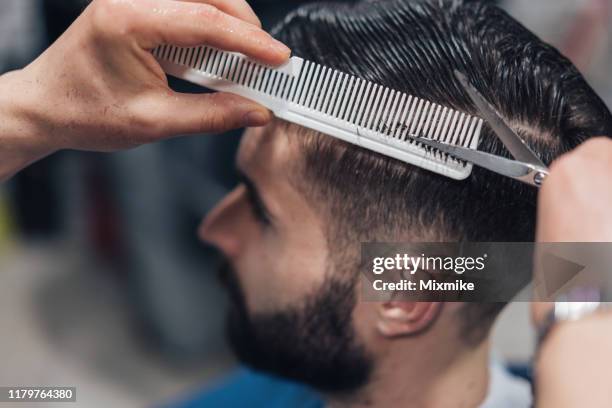 jonge man krijgt stijlvolle kapsel - hairstyle stockfoto's en -beelden