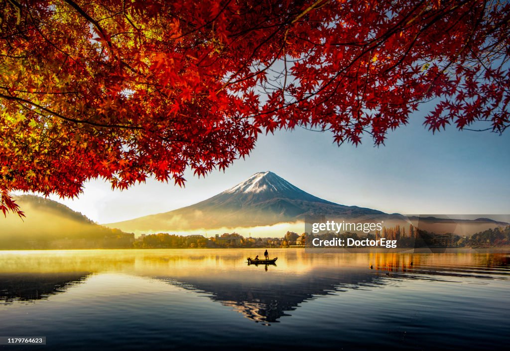 Fuji Mountain and Fisherman Boat with Morning Mist in Autumn, Kawaguchiko Lake, Japan