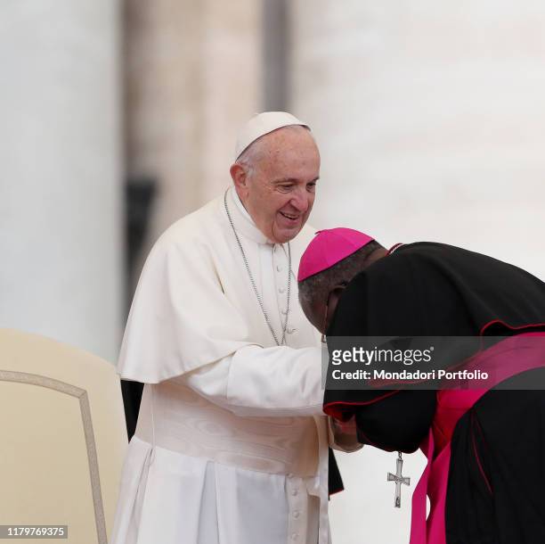 Pope Francis officiating the General Audience in Saint Peter's square. Bishop kissing the Pope's hand. Vatican City, 15th November 2017