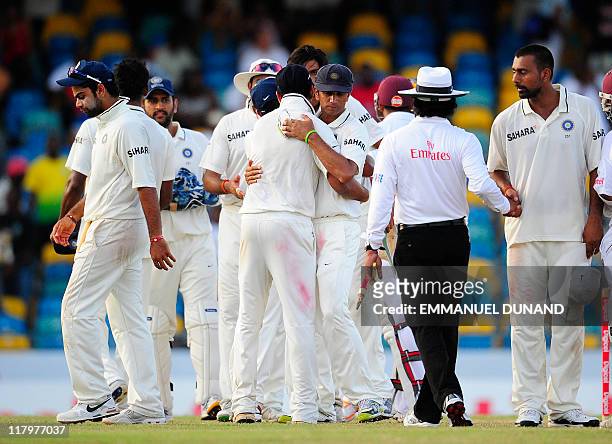 Indian players congratulate each others after rain interuptions led to a draw, at the end of the fifth day of the second test match between West...