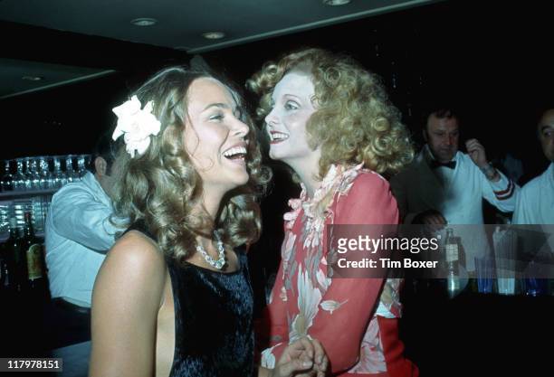 American singer Michele Phillips poses with South African singer and actress Genevieve Waite at a party at Le Club, New York, New York, July 1974. At...