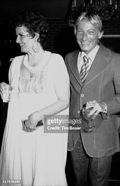 American actress Jane Russell poses with an unidentified man during her birthday party at the Spindletop restaurant, New York, New York, June 1971.