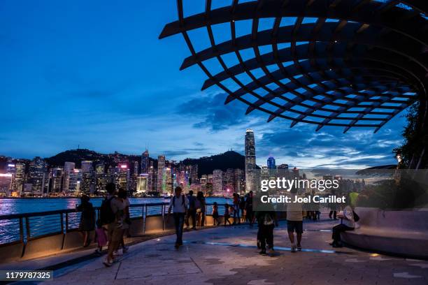 hong kong island skyline viewed from kowloon waterfront - kowloon stock pictures, royalty-free photos & images