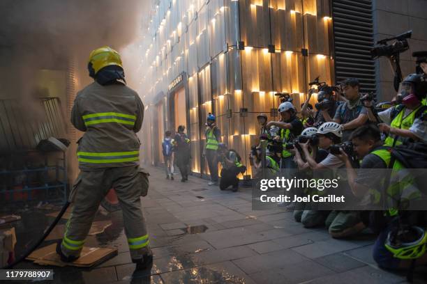 photojournalists and fireman at work in hong kong - photojournalist stock pictures, royalty-free photos & images