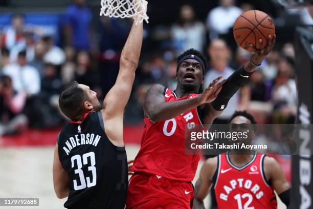 Terence Davis of Toronto Raptors drives to the basket against Ryan Anderson of Houston Rockets during the preseason game between Houston Rockets and...