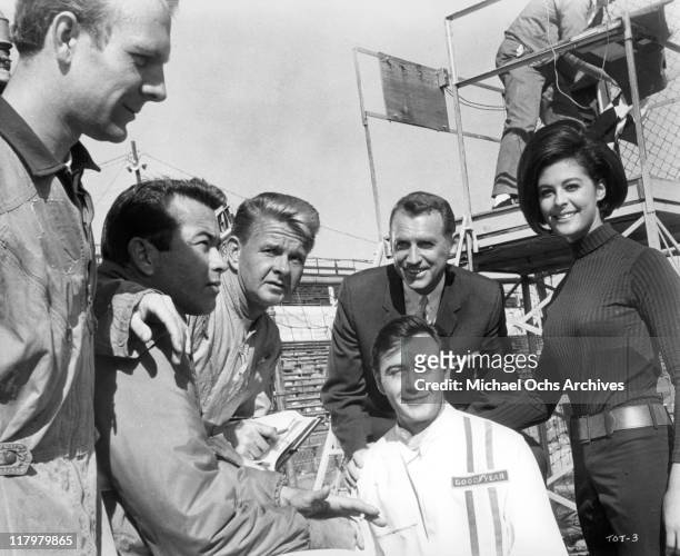 Tommy Kirk, a top racing driver, surrounded by Ray Stricklyn, James Dobson, Chet Stratton, and Brenda Benet in a scene from the film 'Track of...