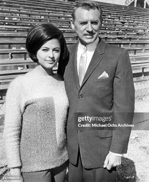 Brenda Benet with Chet Stratton at the racetrack in a scene from the film 'Track of Thunder', 1967.