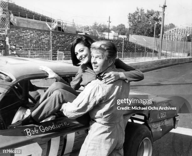 James Dobson gives Brenda Benet a "lift" in a scene from the film 'Track of Thunder', 1967.