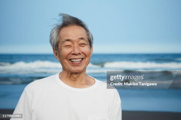 senior man on sunny beach - portraits laugh ストックフォトと画像