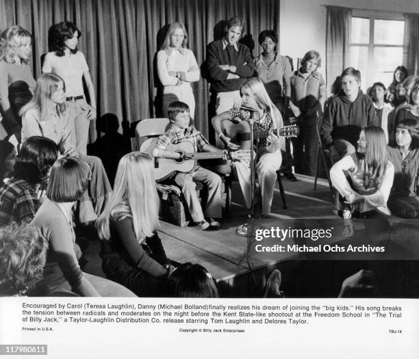 Michael Bolland plays song with the help of Teresa Laughlin are brought together by the Indians in a scene from the film 'The Trial of Billy Jack',...