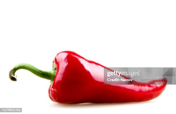 close-up of red chili pepper against white background - jalapeno stock-fotos und bilder