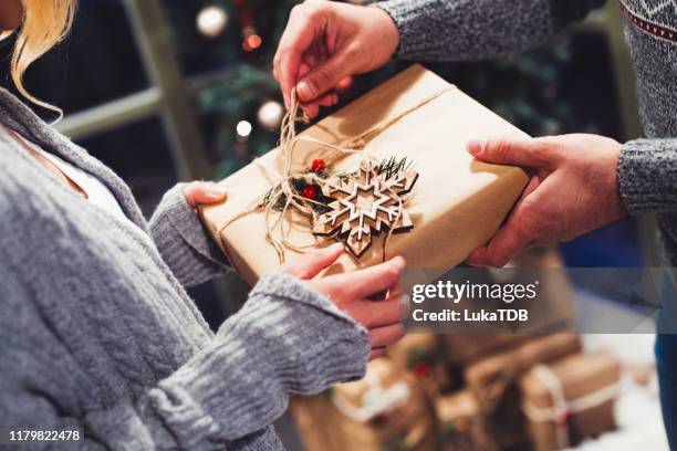 the joy of gift giving at christmastime - christmas togetherness stock pictures, royalty-free photos & images