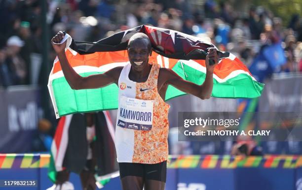 Geoffrey Kamworor of Kenya cheers after he crosses the finish line to win the Professional Men's Finish during the 2019 TCS New York City Marathon in...