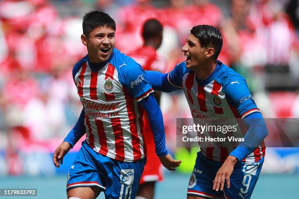 Javier Lopez of Chivas celebrates with teammates after the opening goal of his team during the 17th round match between Toluca and Chivas as part of...