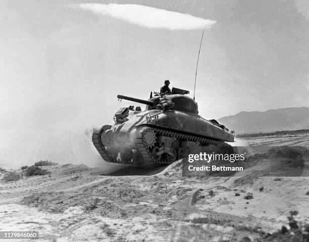 Bumping clumsily over the dusty, uneven terrain of central Tunisia, this tank moves into the battle arena, ready to chase the Axis out of Bir Marbott...