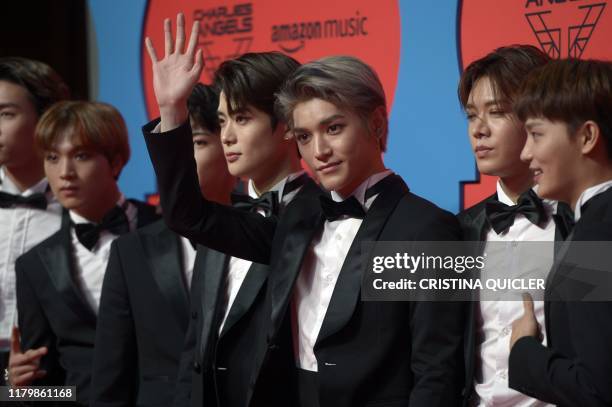 Members of the South Korean boy group NCT 127 pose on the red carpet upon their arrival to the MTV Europe Music Awards at the FIBES Conference and...