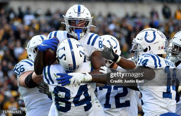 Chester Rogers of the Indianapolis Colts celebrates with Jack Doyle after a 4-yard touchdown reception in the fourth quarter during the game against...