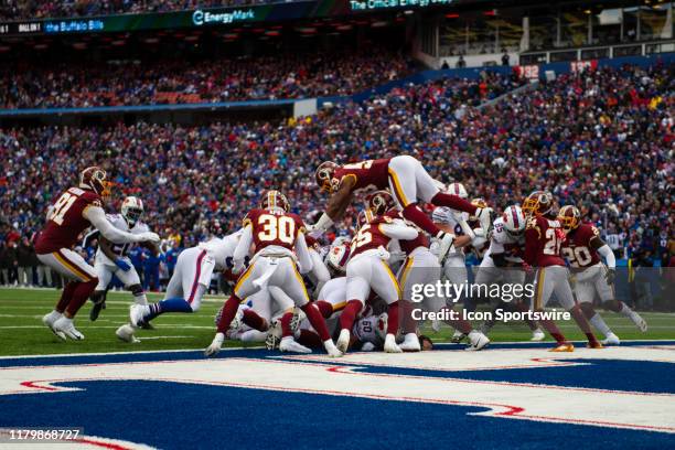 Buffalo Bills Quarterback Josh Allen runs the ball for a touchdown with Washington Redskins Linebacker Joe Bostic leaping to defend during the first...