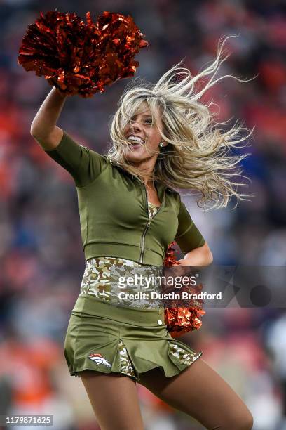 Denver Broncos cheerleader wearing a Veteran's Day-inspired uniform performs during a game against the Cleveland Browns at Empower Field at Mile High...