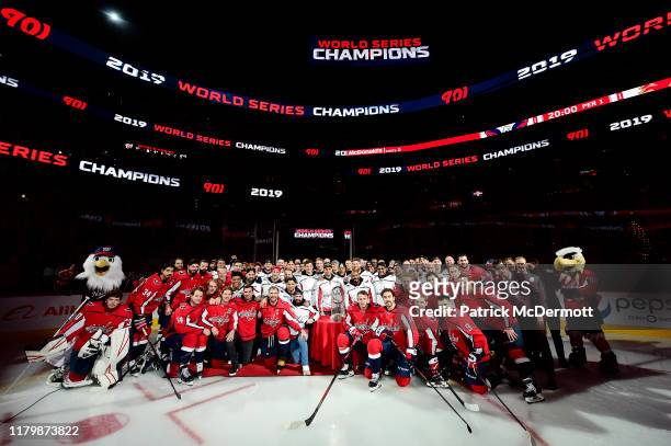The Washington Capitals and Washington Nationals pose for a photo after the Nationals were honored during a pregame ceremony to celebrate the...