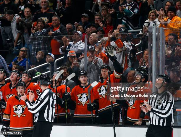 Ryan Getzlaf of the Anaheim Ducks acknowledges the crowd as he is recognized for his playing in his 1,000th NHL career game in the first period of...