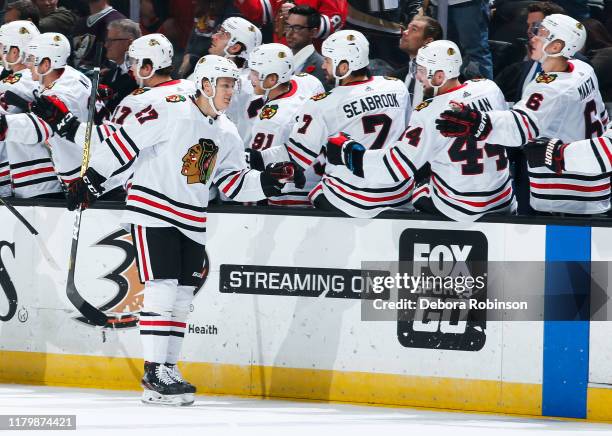 Adam Boqvist of the Chicago Blackhawks celebrates his first-period goal with the bench during the game against the Anaheim Ducks at Honda Center on...