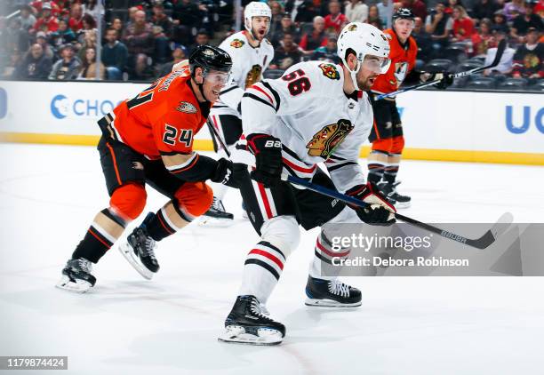 Carter Rowney of the Anaheim Ducks and Erik Gustafsson of the Chicago Blackhawks race for the puck during the first period of the game at Honda...