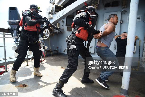 The Nigerian Navy Special forces pretend to arrest pirates on F375 Germinal French Frigate in a stage managed operations during the five-day joint...