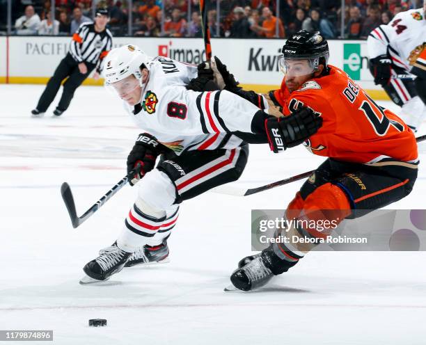 Dominik Kubalik of the Chicago Blackhawks and Michael Del Zotto of the Anaheim Ducks battle for the puck during the second period of the game at...