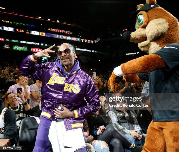 Snoop Dogg reacts after being given a spurs t-shirt by San Antonio Spurs Coyote at AT&T Center on November 03, 2019 in San Antonio, Texas. NOTE TO...