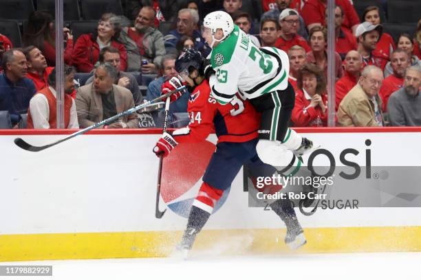 Esa Lindell of the Dallas Stars collides with and is called for a roughing penalty on Jonas Siegenthaler of the Washington Capitals in the first...