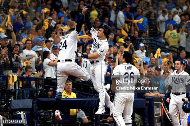 Willy Adames of the Tampa Bay Rays is congratulated by his teammates after hitting a solo home run against the Houston Astros during the fourth...