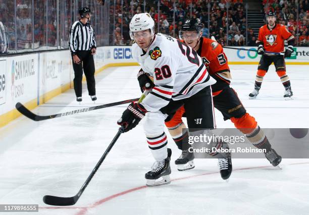 Brandon Saad of the Chicago Blackhawks and Jakob Silfverberg of the Anaheim Ducks battle for the puck during the third period of the game at Honda...