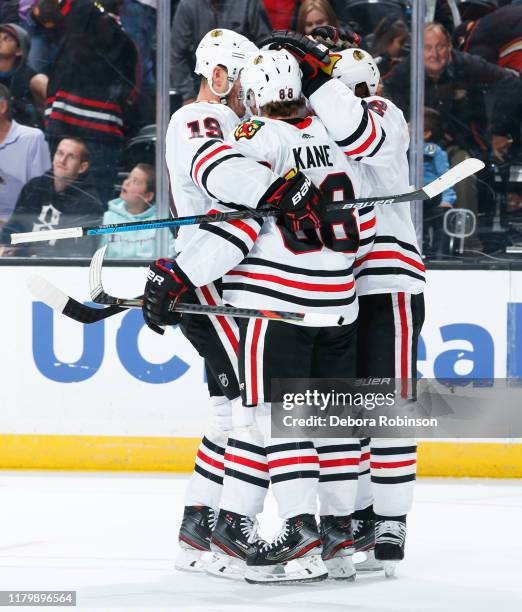 Jonathan Toews, Patrick Kane and Duncan Keith of the Chicago Blackhawks celebrate Kanes game-winning goal during overtime of the game against the...