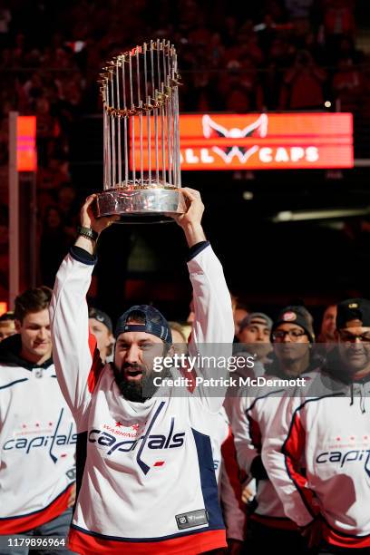 Adam Eaton of the Washington Nationals holds the Commissioner's Trophy as the Nationals are honored during a pregame ceremony to celebrate the...