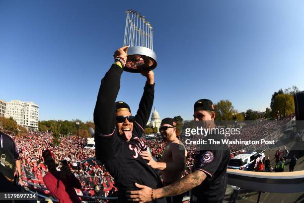 Washington Nationals left fielder Juan Soto hoists the championship trophy during the parade to honor the 2019 World Series Champion Washington...