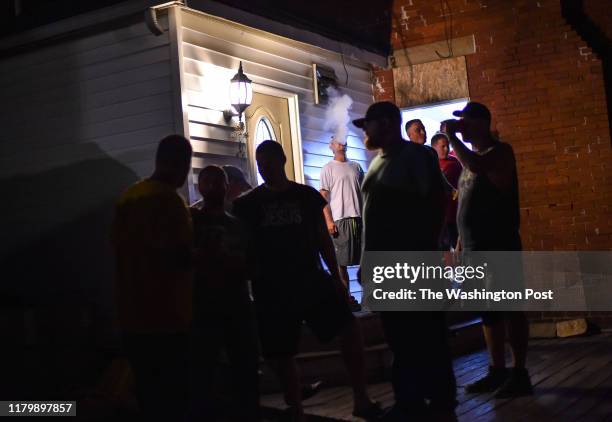 Recovering addicts are seen spending time with each other in the back yard of The Farm recovery center on October 1, 2019 in Huntington, WV....