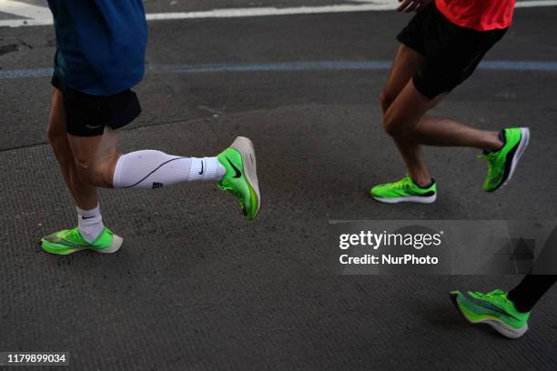 Runners wearing lime green Nikes compete at the New York City Marathon Sunday November 3rd, 2019. The NYC Marathon, which is the largest race in the...