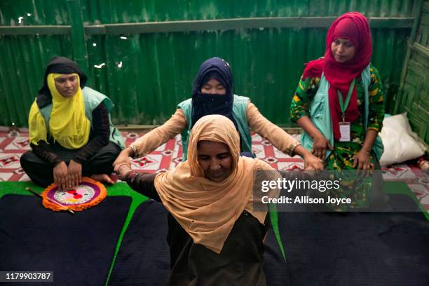 Women participate in a therapy session at the RW Welfare Society healing center in the Rohingya refugee camp on October 27, 2019 in Cox's Bazar,...