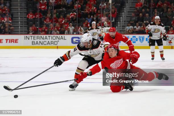 Tyler Bertuzzi of the Detroit Red Wings dives and knocks the puck off the stick of Adam Henrique of the Anaheim Ducks during the third period at...