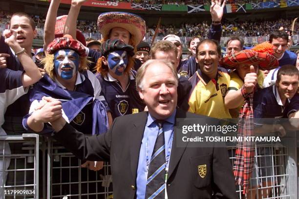 Scotish coach Craig Brown salutes Scotish supporters 10 June at the Stade de France in Saint Denis before the opening ceremony of the 1998 Soccer...