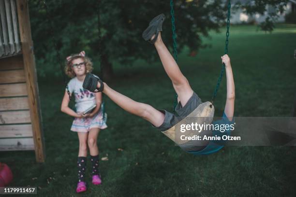 kids playing on backyard swing-set - backyard swing set stock pictures, royalty-free photos & images