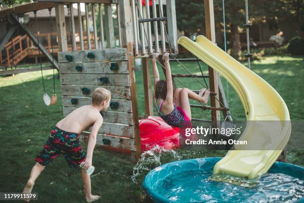 summer children playing in backyard - spielplatz einrichtung stock-fotos und bilder