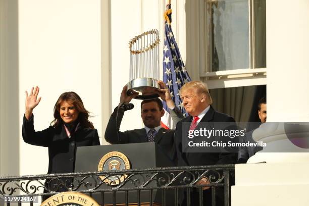 First baseman Ryan Zimmerman holds up the Commissioner's Trophy as U.S. President Donald Trump and first lady Melania Trump welcome the 2019 World...