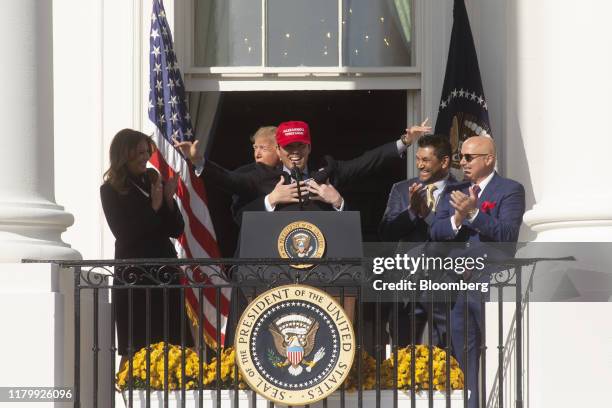 President Donald Trump hugs Kurt Suzuki, catcher for the Washington Nationals, center, during a celebration for the 2019 Major League Baseball World...