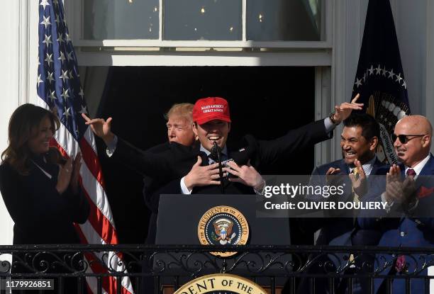 Baseball player Kurt Suzuki wears a "Make America Great Again" hat as US President Donald Trump and First Lady Melania Trump welcome the 2019 World...