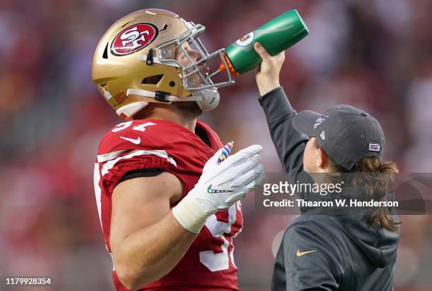 Nick Bosa of the San Francisco 49ers takes a drink of water while there's a break in the action against the Cleveland Browns during the second...