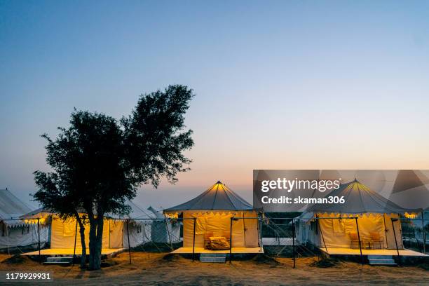 sunset landscape view of camping tents near the desert near bikaner rajasthan india - bikaner stock pictures, royalty-free photos & images