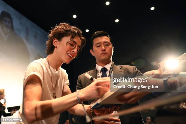 Actor Timothee Chalamet signs an autograph at the screening of "The King" during day 7 of the 24th Busan International Film Festival at the Busan...